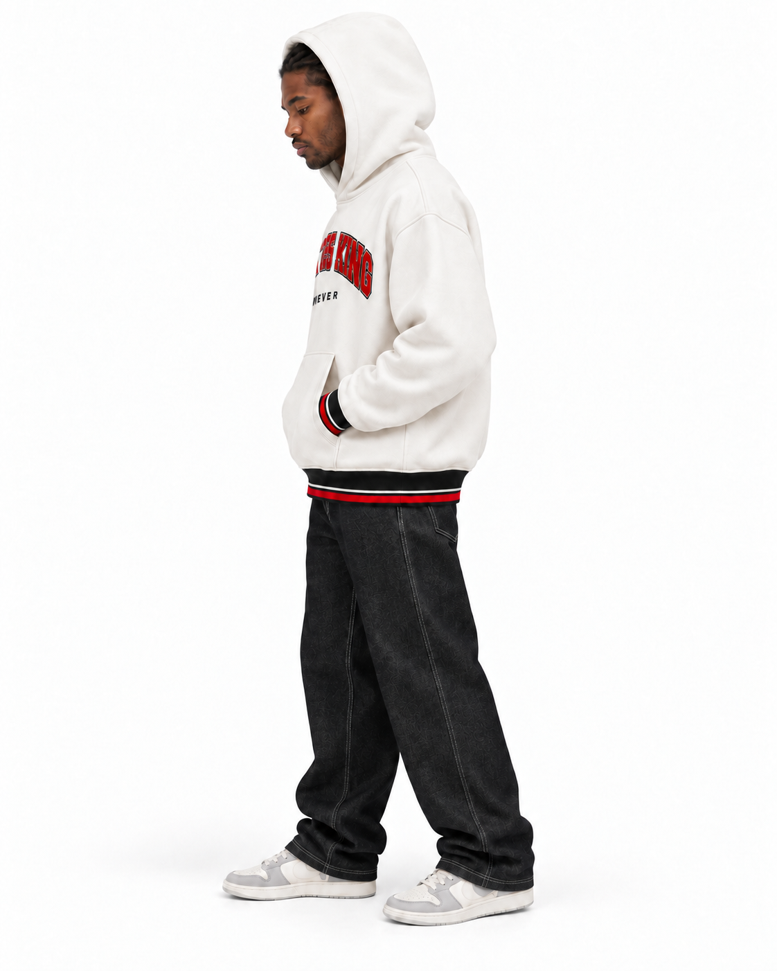 Full-body side profile of a model wearing the white CHRIST IS KING FOREVER Varsity Hoodie with the hood up, black jeans, and gray-and-white sneakers.